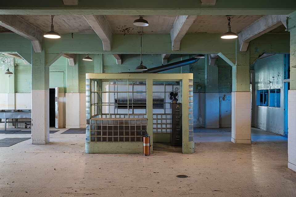 The empty kitchen of the Alcatraz cellhouse, its serving counter caged in steel mesh