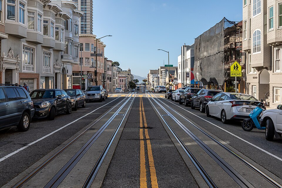 Cable car tracks running down the middle of Mason Street between parked cars