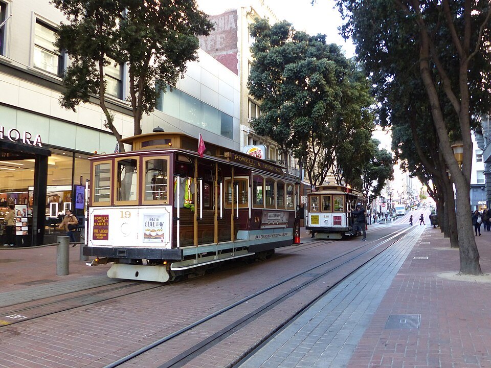 Cable cars on the lower end of Powell Street, among the shops