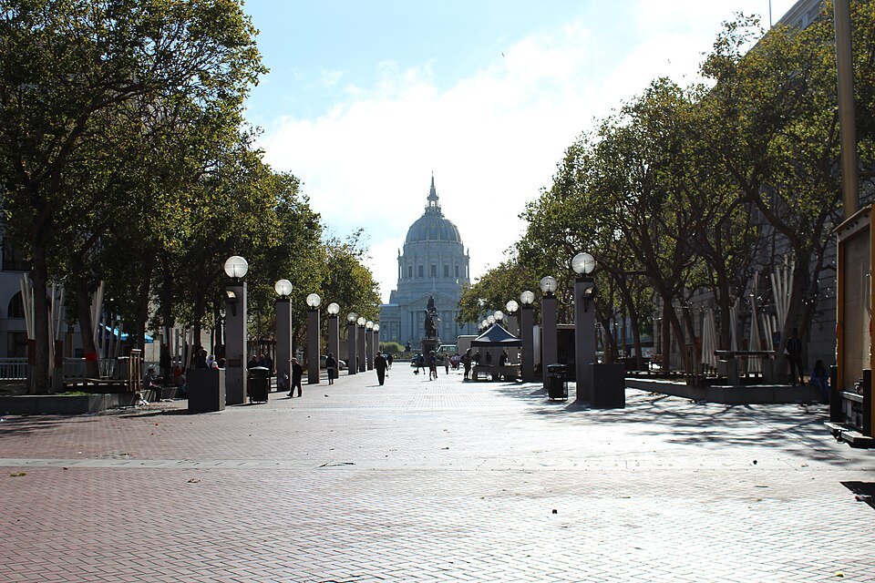 The dome of City Hall at the end of the tree-lined Civic Center plaza