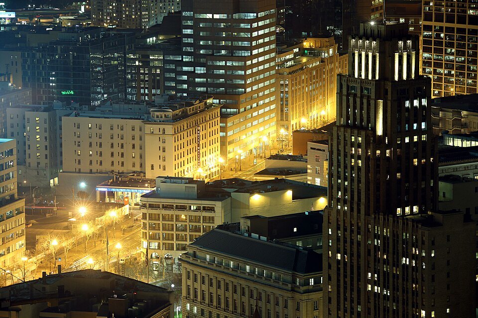 The Civic Center and Market Street lit up at night, seen from above