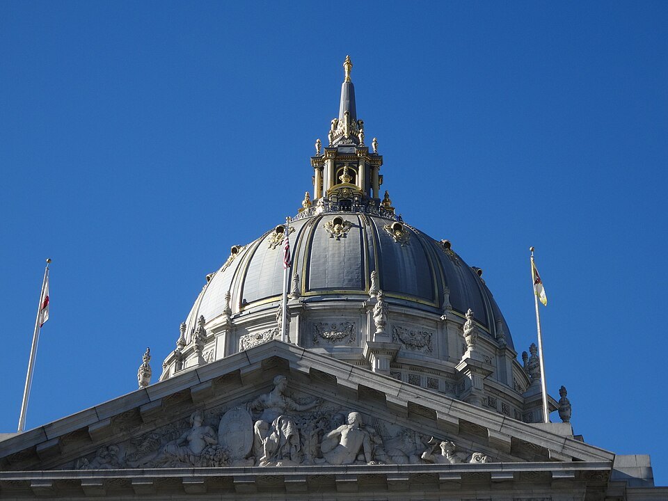 The ribbed dome of City Hall rising over the sculpted pediment