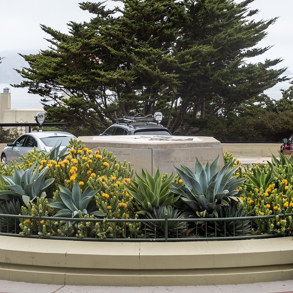 Succulents and flowers planted around the base of the Columbus statue in Pioneer Park