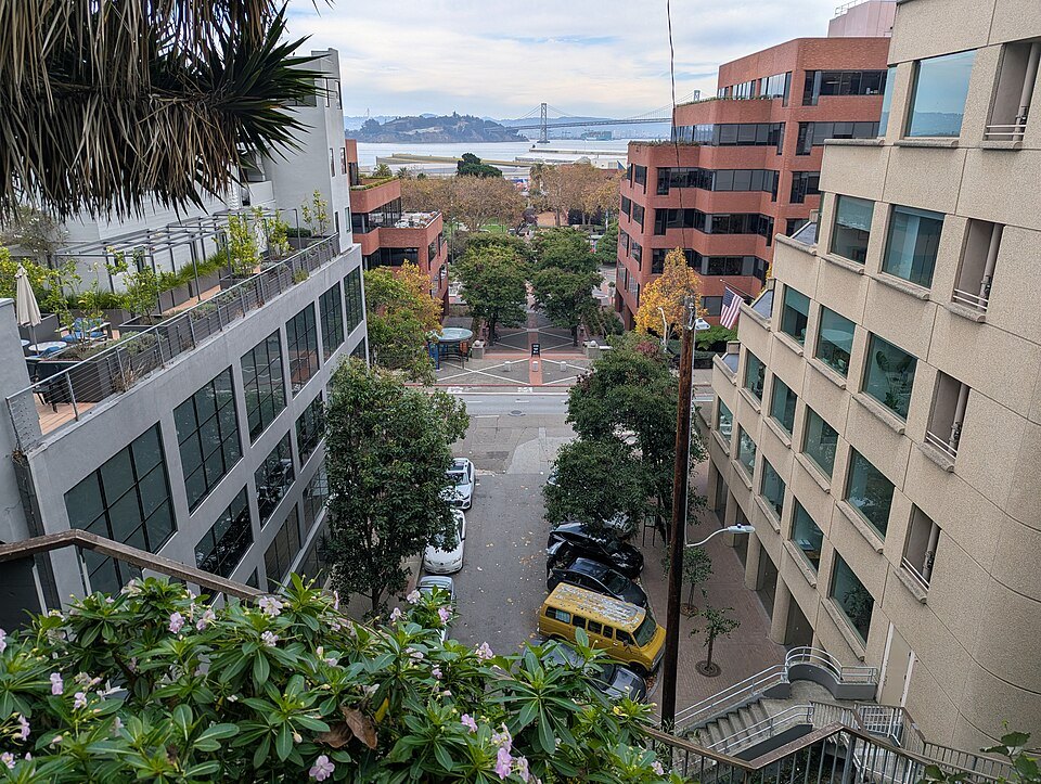 Looking down the Filbert Steps into Levi's Plaza, with the Bay Bridge beyond