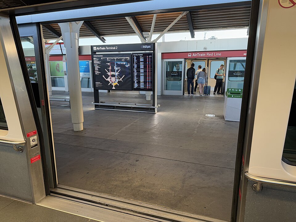 The doors of an AirTrain car opening onto a terminal platform at SFO