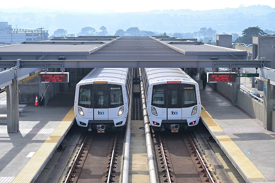 Two BART trains waiting side by side at Daly City