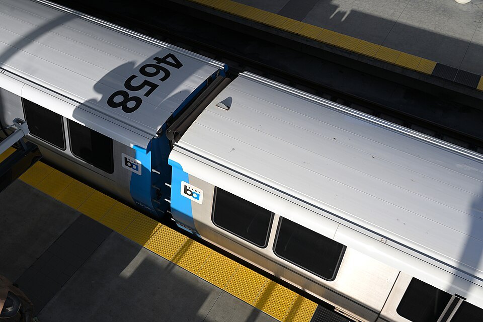 A BART train at Millbrae seen from the footbridge overhead