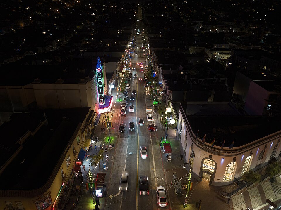 Castro Street from above at night, the Castro Theatre's lit sign on the left