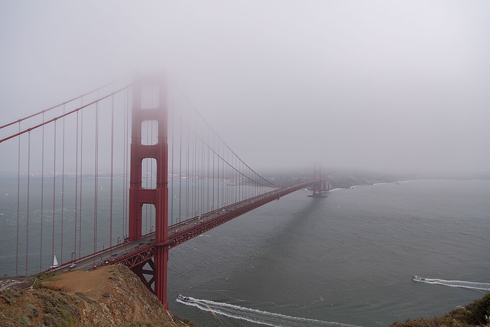 The bridge disappearing into the summer fog, seen from the headlands