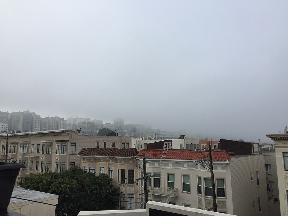 Rooftops under a blanket of early morning fog