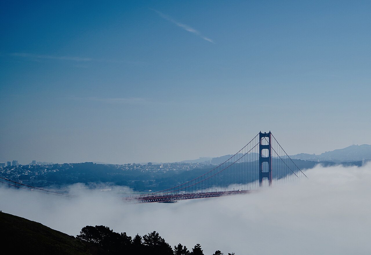 The Golden Gate Bridge's towers rising out of a sea of fog