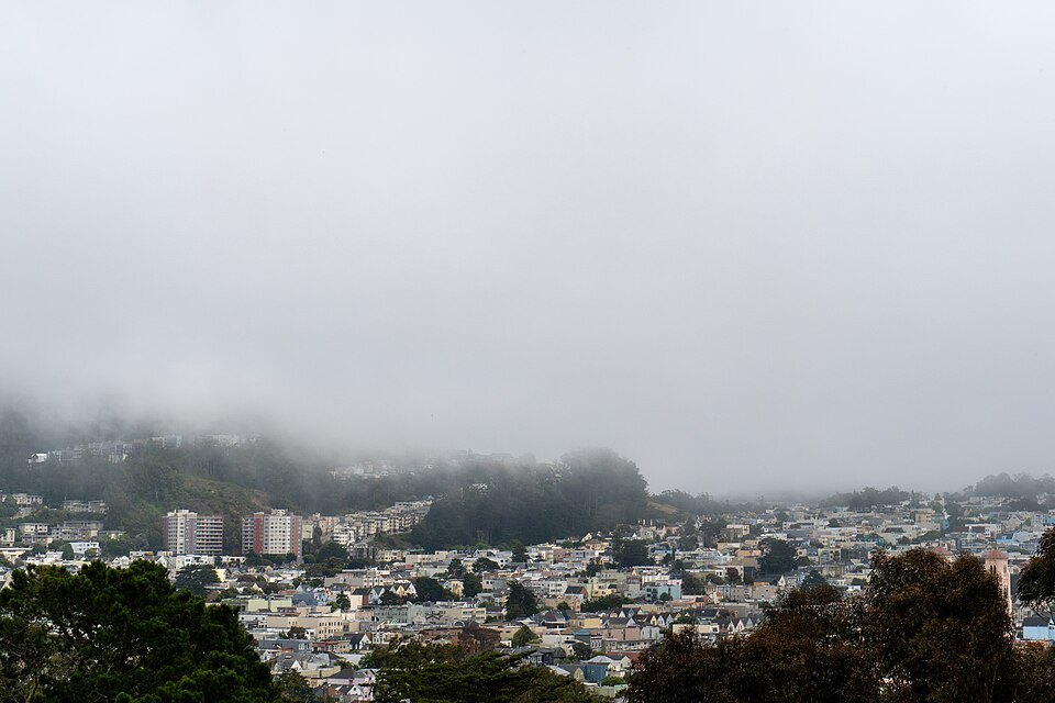 Low fog hanging over the rooftops of the western neighborhoods