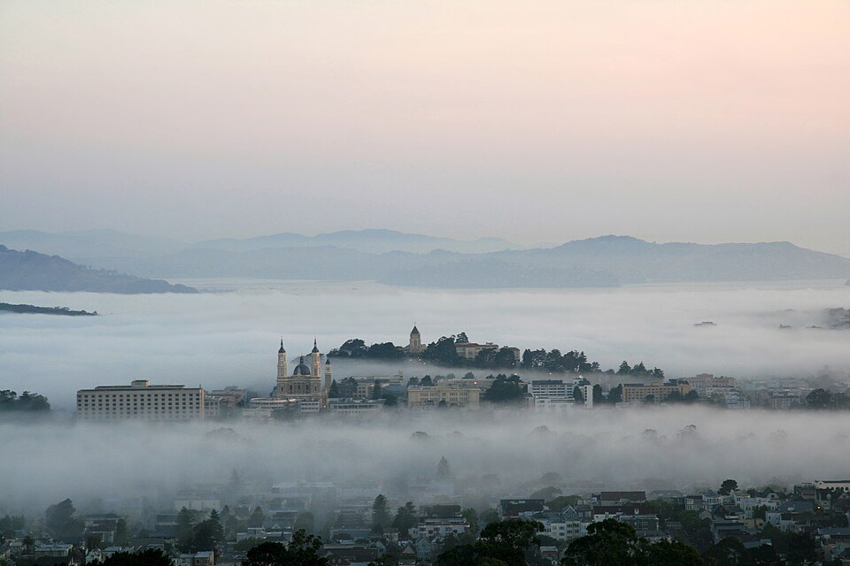 Fog filling the valleys below Twin Peaks at dawn, hilltops above it