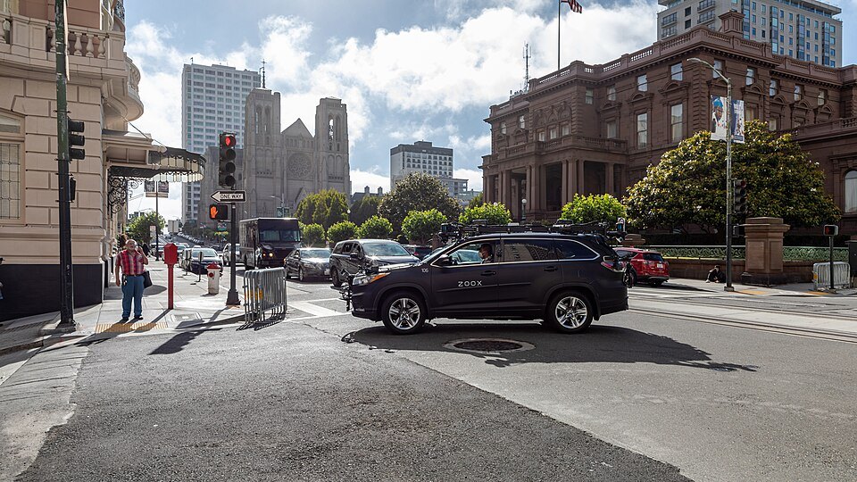 The corner of California Street on Nob Hill, towers down the hill behind