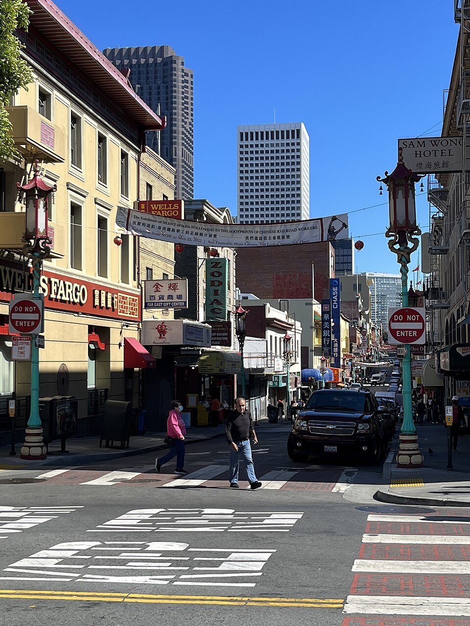 Grant Avenue in Chinatown, its banners and lamps below the downtown towers