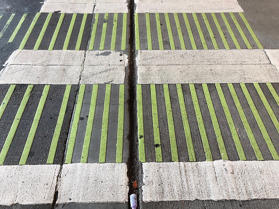 Yellow-green crossing stripes painted on a street in the Dogpatch