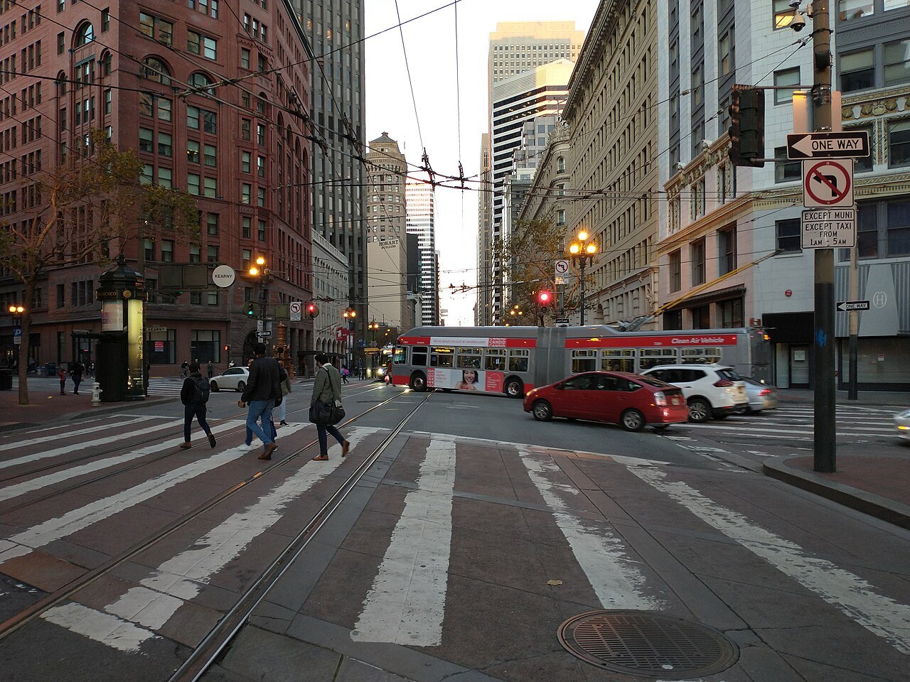 Crossing Market Street at Kearny, a bus and pedestrians in the intersection