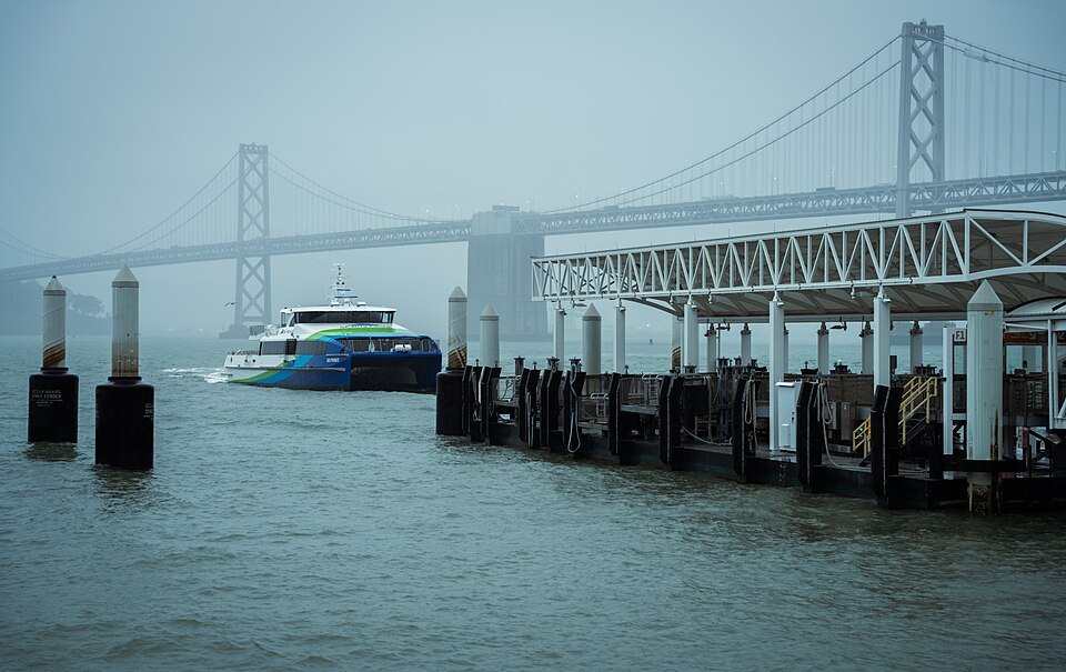 A ferry leaving the Ferry Building's landings, the Bay Bridge in the mist