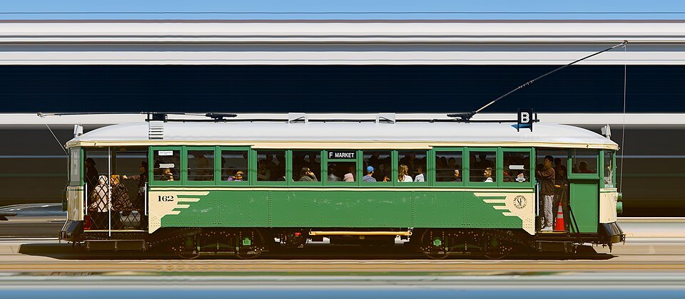 A green vintage streetcar, photographed side-on at a heritage weekend