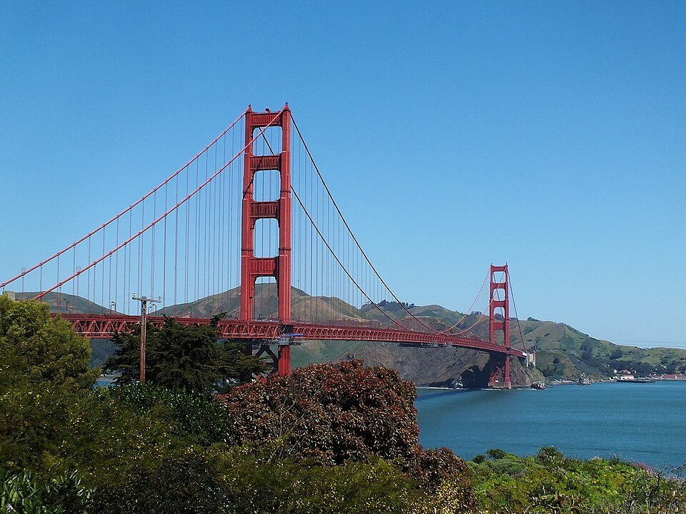 The Golden Gate Bridge in sunshine, the Marin Headlands behind it