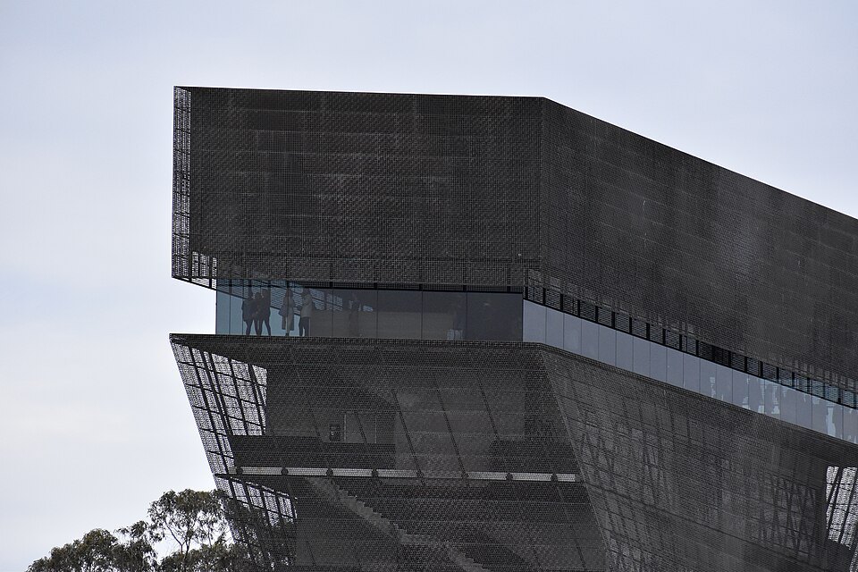 The de Young museum's perforated copper tower against a pale sky