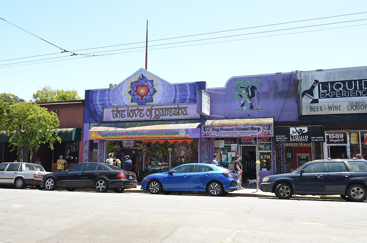 Painted shopfronts along Haight Street, with the purple front of a gift shop