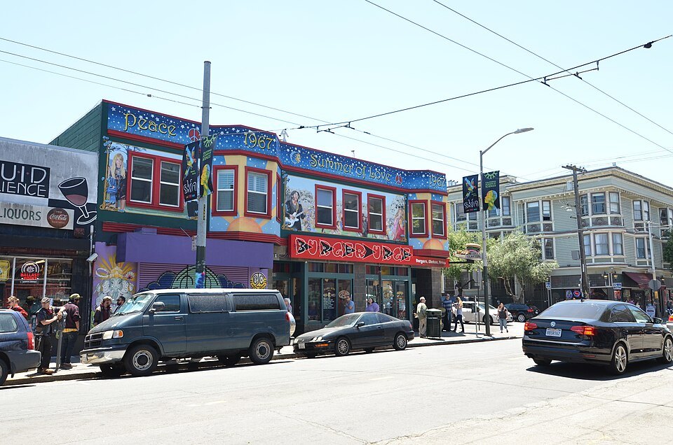 A mural-covered corner building on Haight Street
