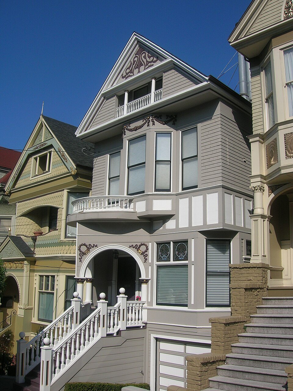 A gray Victorian with its arched porch and tall bay windows