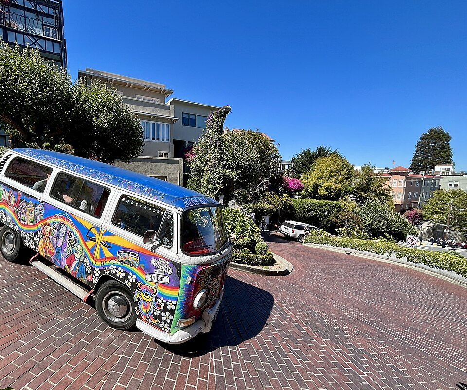 A painted camper van taking one of the brick curves on Lombard Street