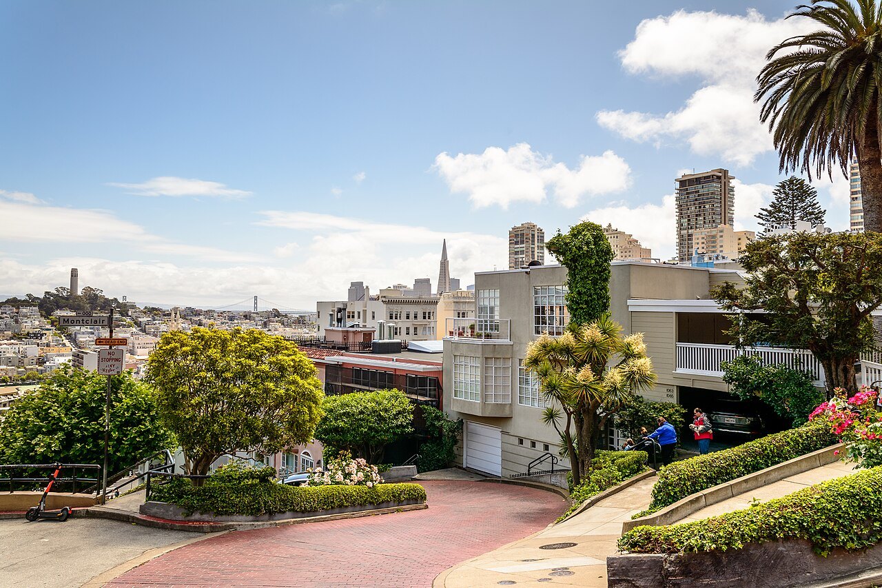 Lombard Street's crooked block, with the Transamerica Pyramid and Coit Tower beyond