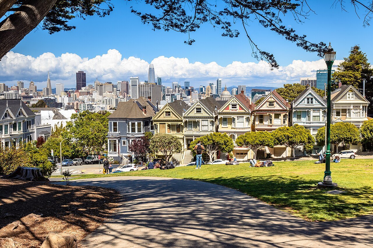 The Painted Ladies across the lawn of Alamo Square, downtown behind them