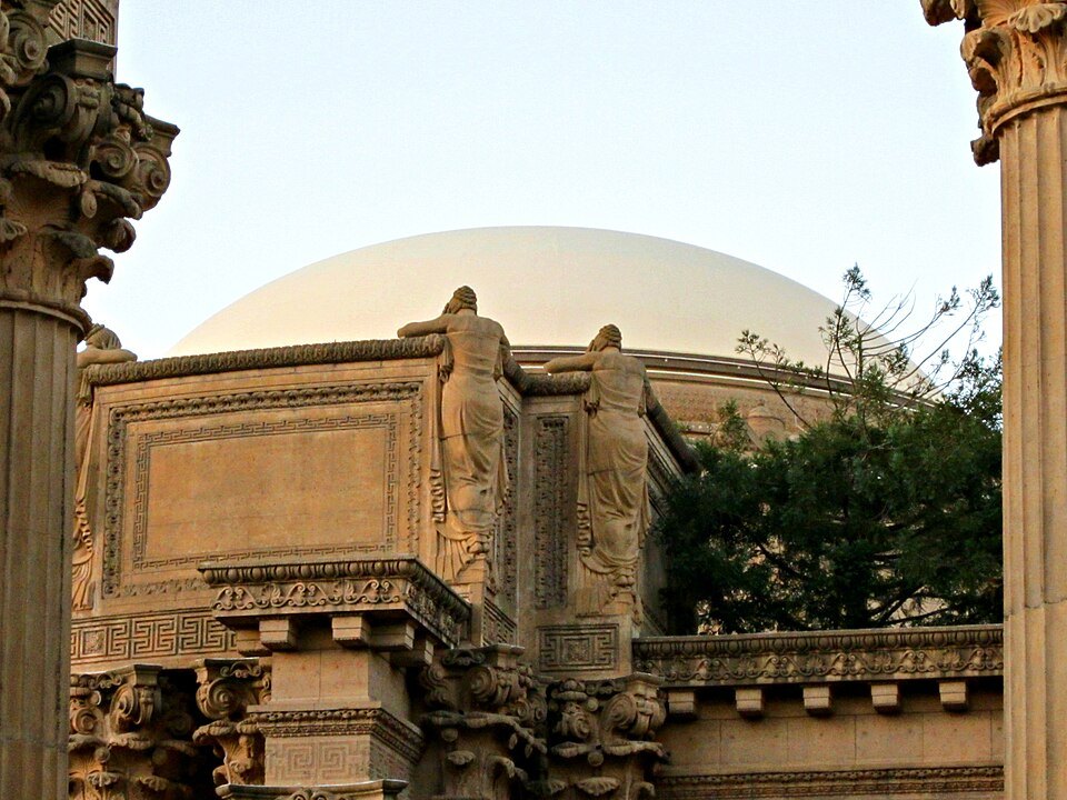Figures carved on the planter boxes atop the colonnade, the dome behind