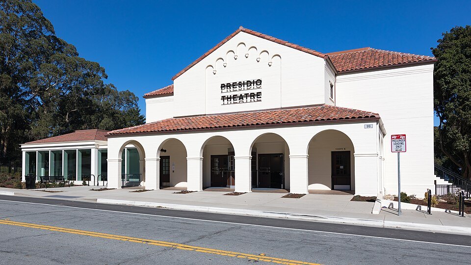 The Presidio Theatre, white stucco and red tile, with its arcade of arches