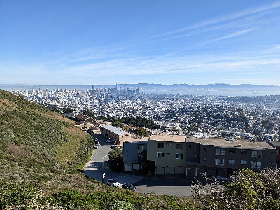 Houses at the foot of Twin Peaks, the whole city spreading beyond
