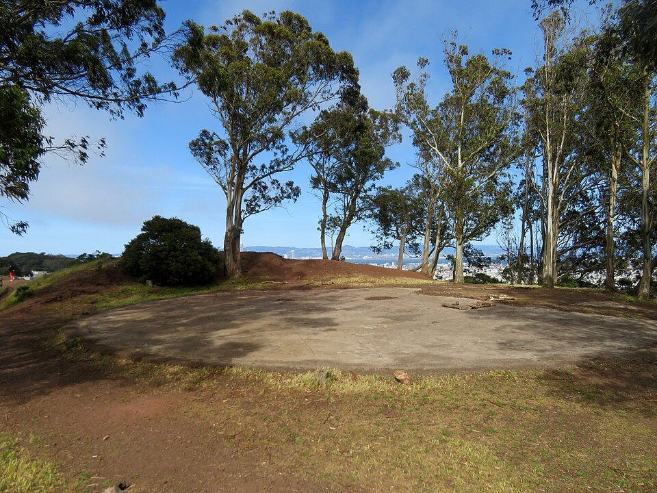 An old concrete foundation under the eucalyptus trees on top of Tank Hill, downtown beyond